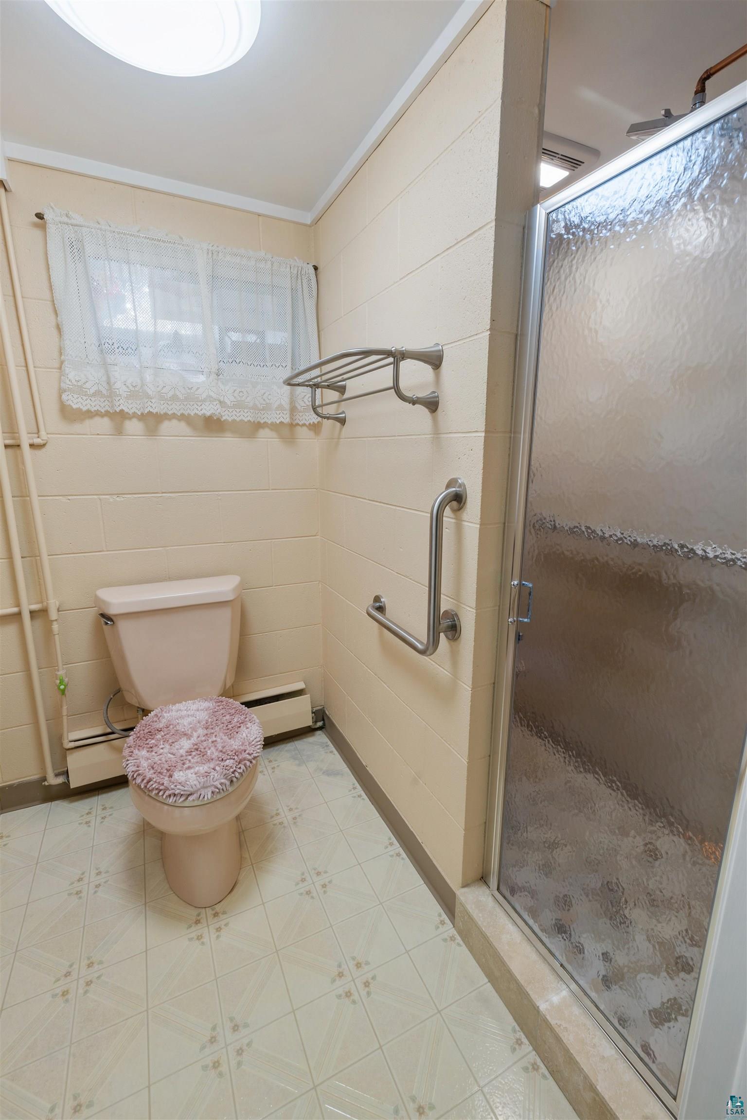 3975 Long Lake Shores Road Eveleth, MN 55734 - Photo 52 of 84 Full bathroom with a stall shower, crown molding, baseboard heating, and light flooring