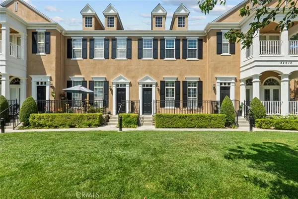 a front view of a house with a yard and trees