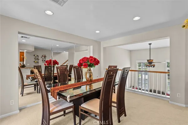 a dining room with furniture and a potted plant