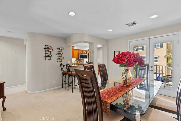 a view of a dining room with furniture and a chandelier
