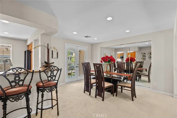 a dining room with furniture and wooden floor