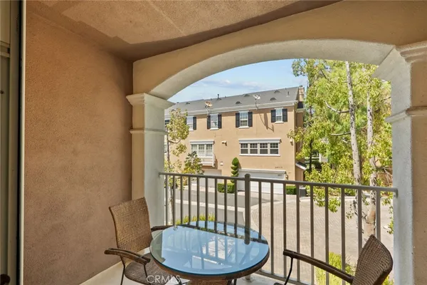 a view of a chairs and table in a balcony
