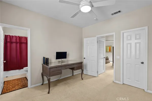 a view of a workspace with furniture and a bathroom