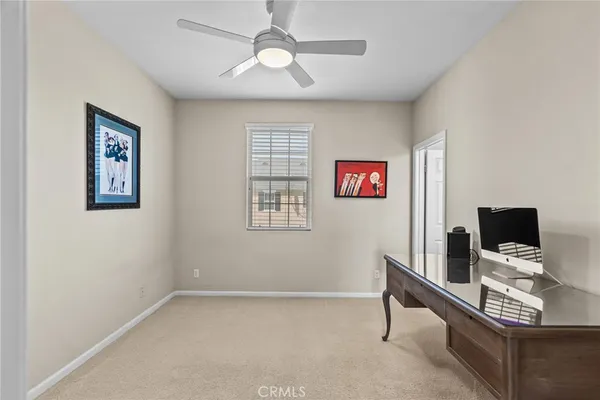 a view of a workspace with furniture and a window