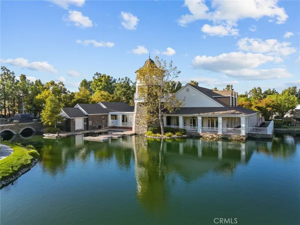 a aerial view of a house with swimming pool patio and lake view