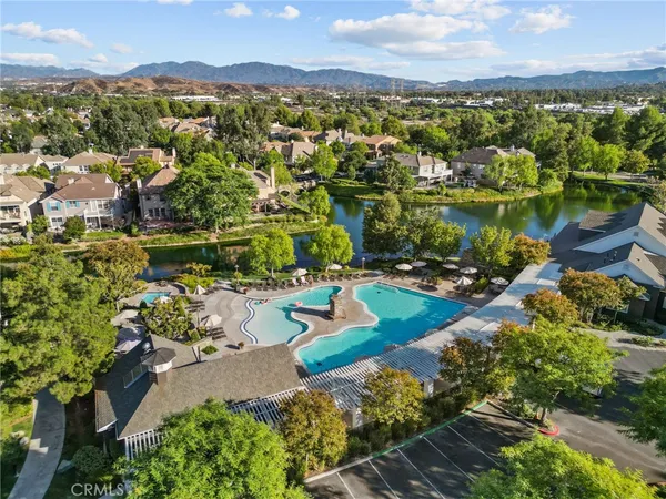 an aerial view of residential houses with outdoor space and river