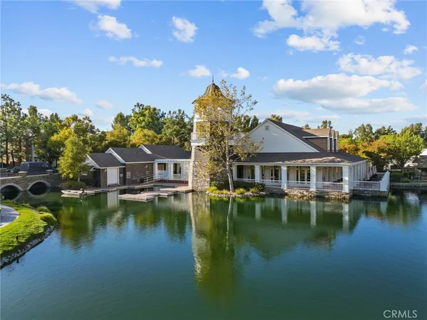a aerial view of a house with swimming pool patio and lake view