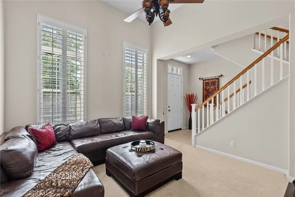 a living room with furniture and a potted plant
