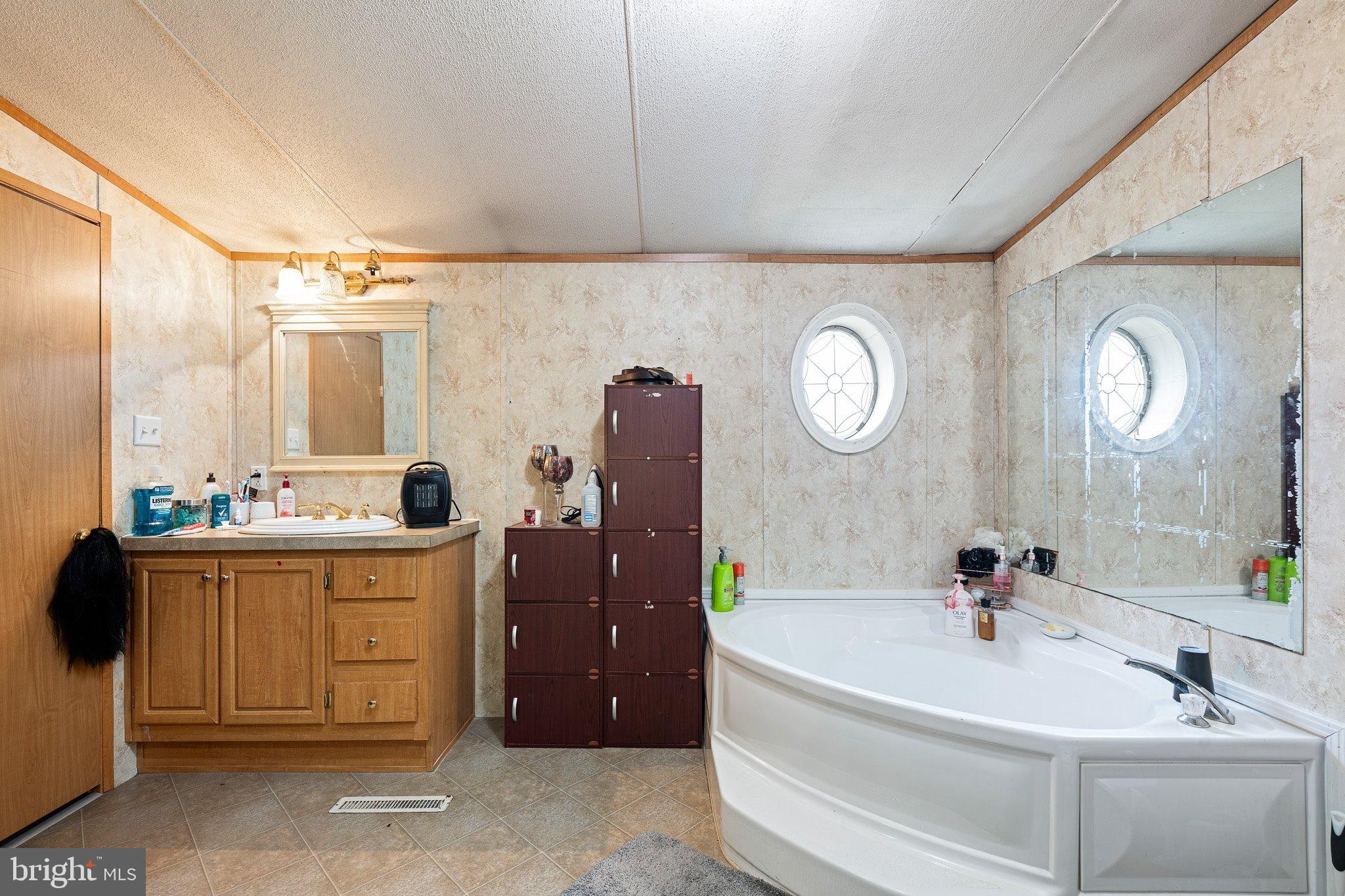 1650 Cypress Branch Road Magnolia, DE 19962 - Photo 21 of 35 Spacious bathroom with elegant round window.
