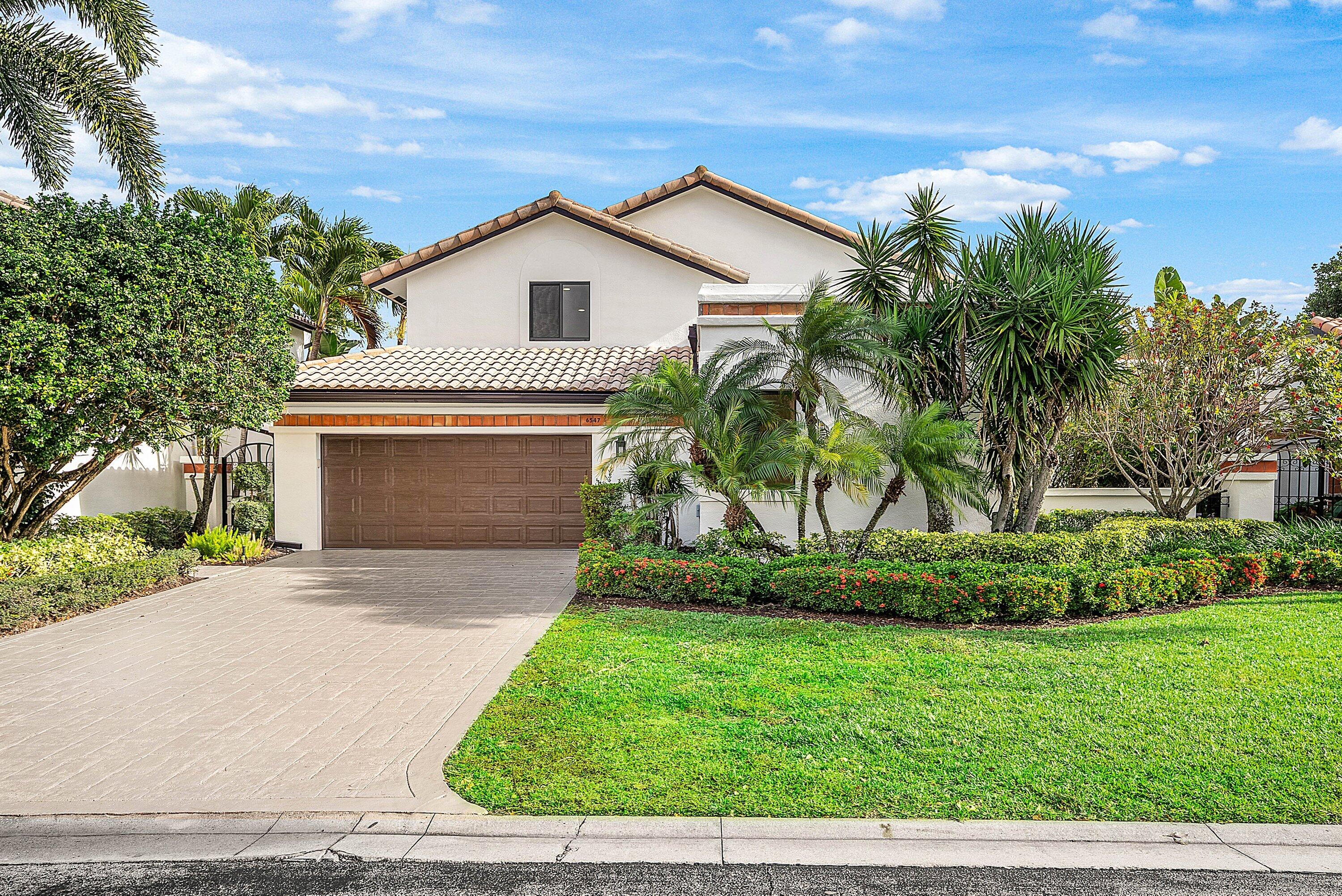 6547 Via Rosa Boca Raton, FL 33433 - Photo 1 of 55 a front view of a house with a yard and garage