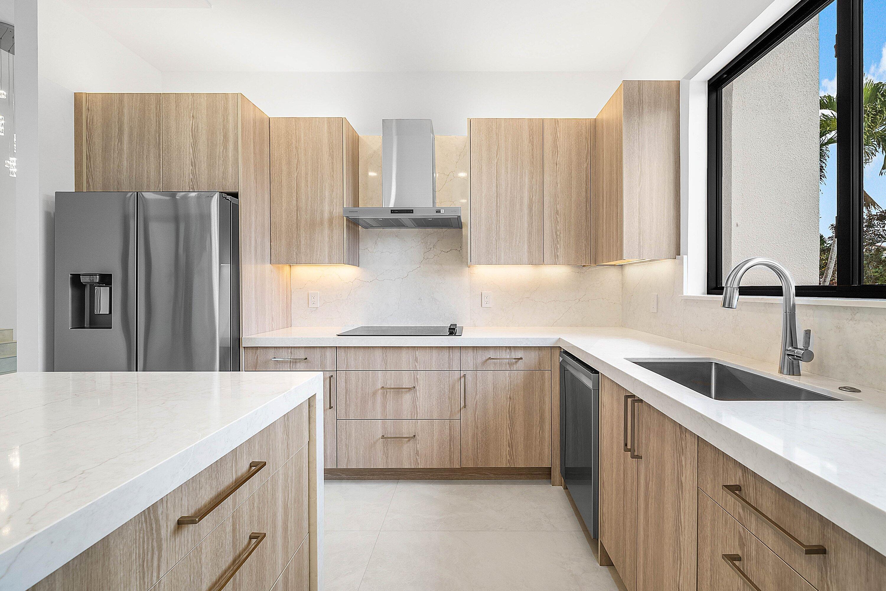 6547 Via Rosa Boca Raton, FL 33433 - Photo 14 of 55 a kitchen with stainless steel appliances a sink cabinets and a refrigerator