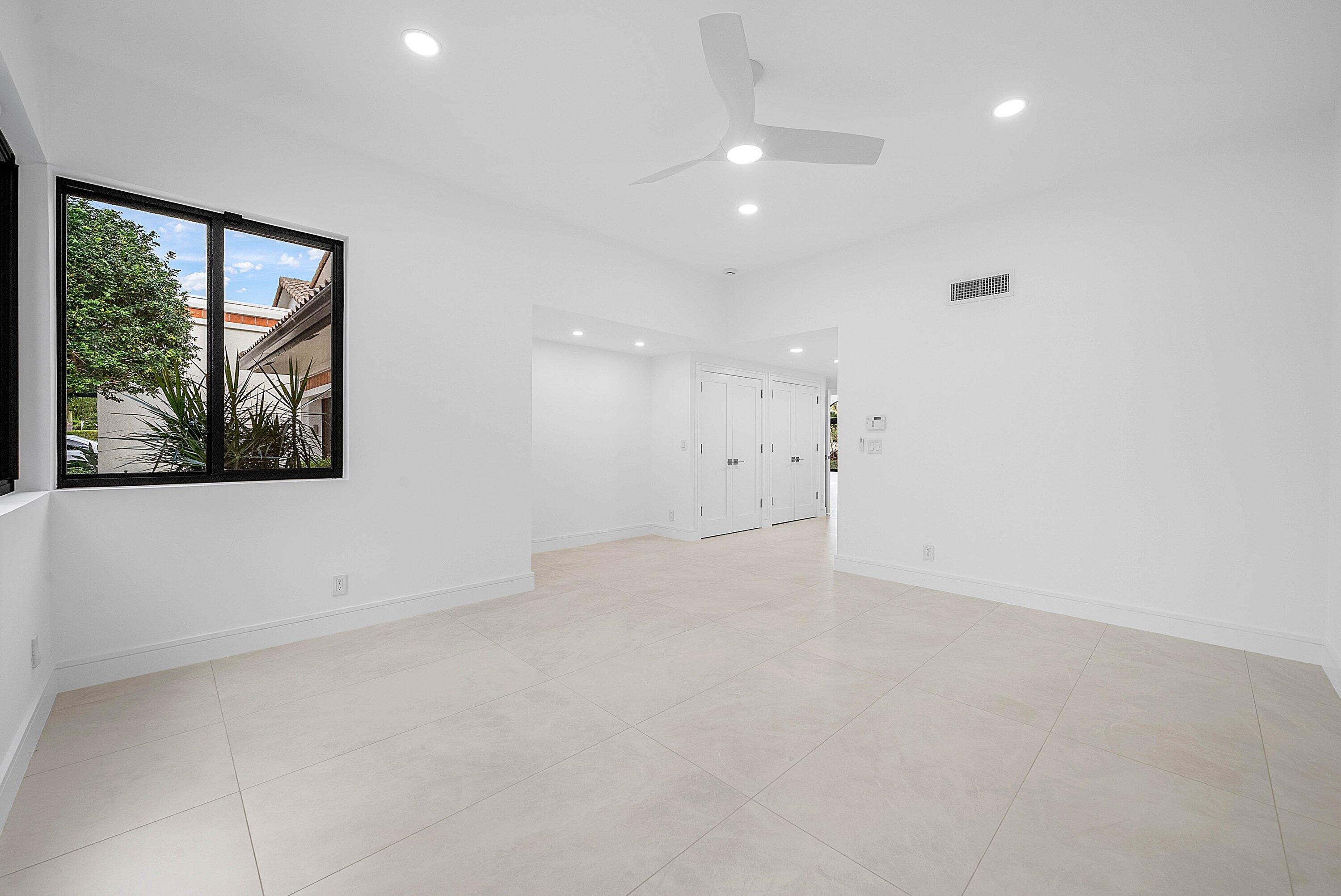 6547 Via Rosa Boca Raton, FL 33433 - Photo 20 of 55 a view of an empty room with a window and a ceiling fan