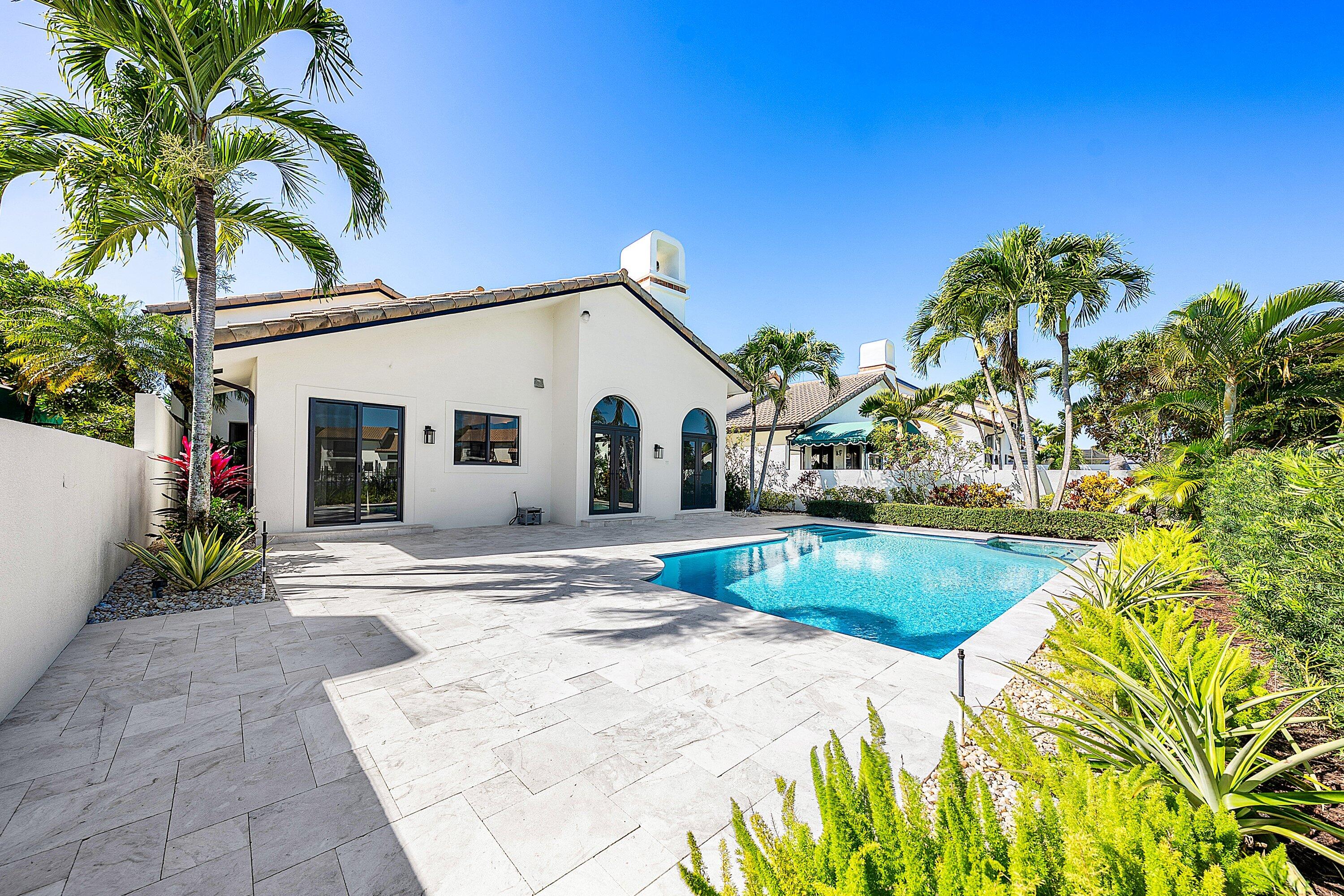 6547 Via Rosa Boca Raton, FL 33433 - Photo 44 of 55 a view of a white house with a yard