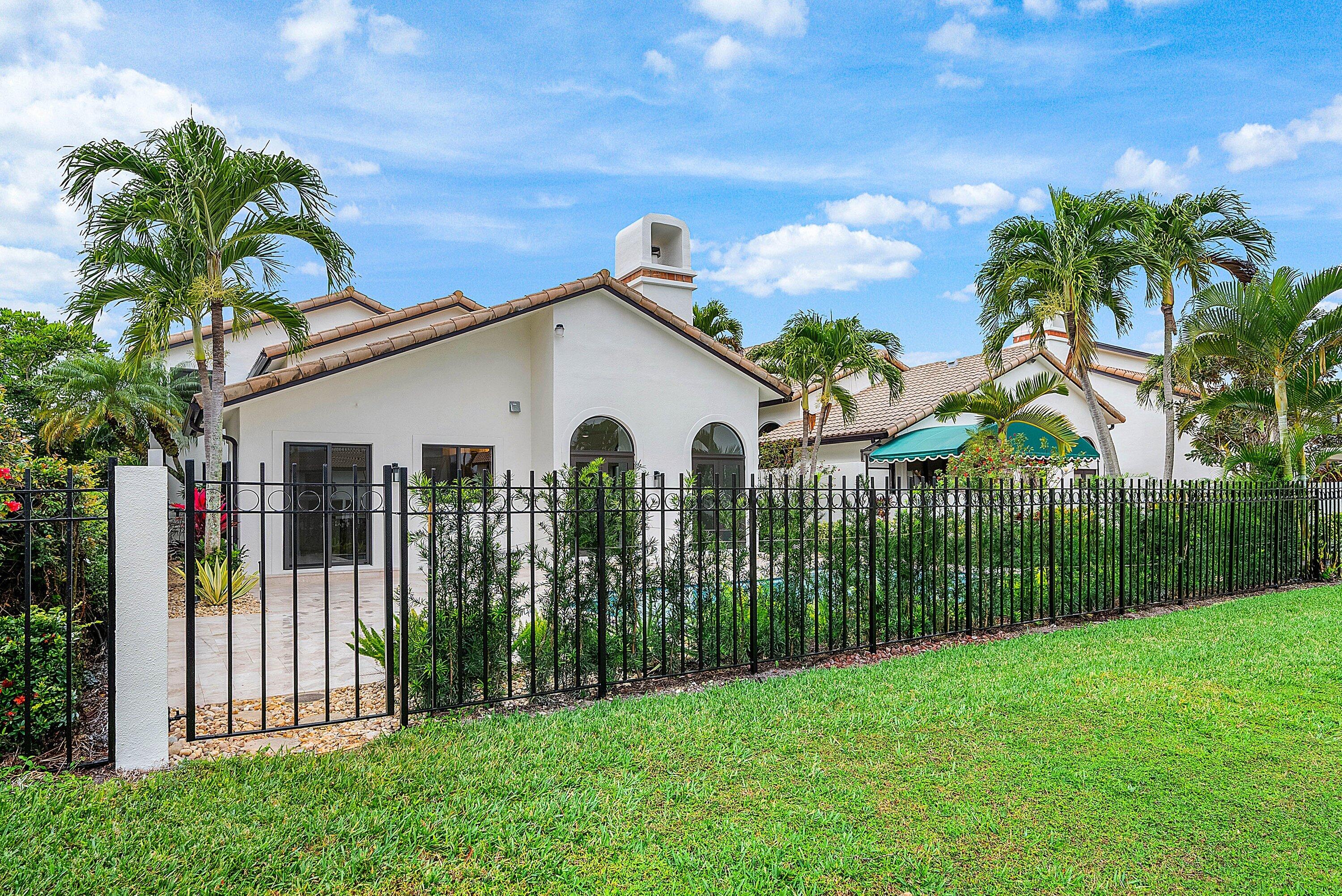 6547 Via Rosa Boca Raton, FL 33433 - Photo 46 of 55 a view of a white house with a big yard and potted plants
