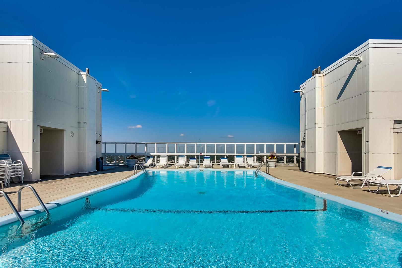 5733 North Sheridan Road, Unit 23B Chicago, IL 60660 - Photo 28 of 33 a view of a swimming pool with an outdoor seating and house