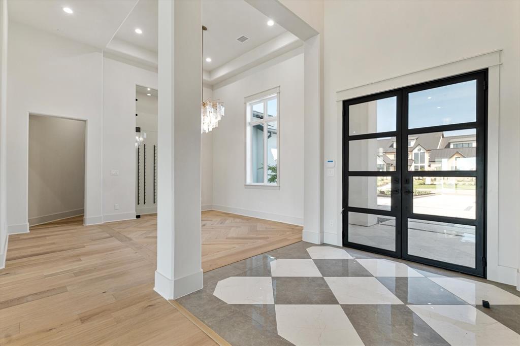 312 Longview Place Heath, TX 75032 - Photo 11 of 40 a view of a hallway with wooden floor and windows