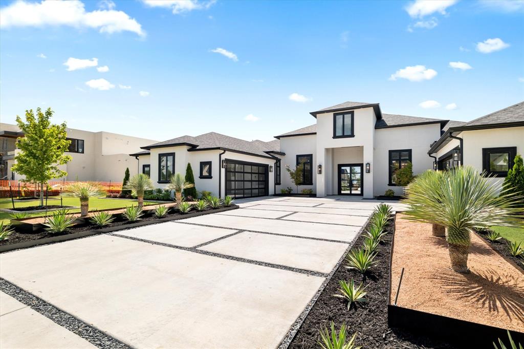 312 Longview Place Heath, TX 75032 - Photo 4 of 40 a front view of a house with a garden and plants