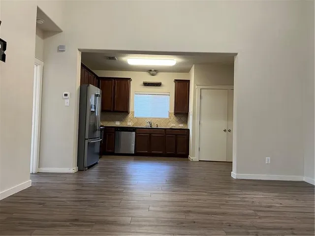 a kitchen with stainless steel appliances a sink and a refrigerator