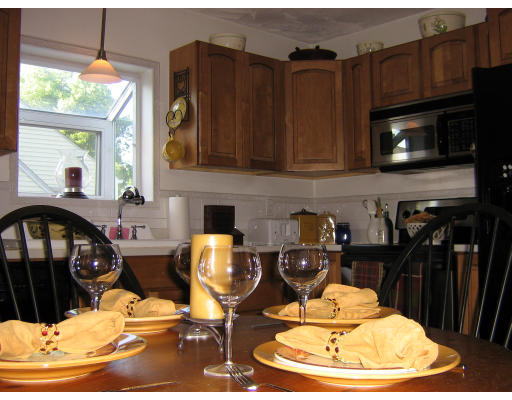 105 Redlands Street Springfield, MA 01104 - Photo 9 of 18 a kitchen with granite countertop a stove and a dining table
