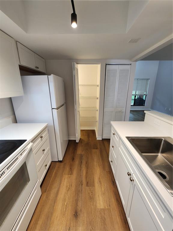 5823 Southwest 9th Place, Unit H55 Gainesville, FL 32607 - Photo 19 of 50 a kitchen with granite countertop white cabinets and white appliances