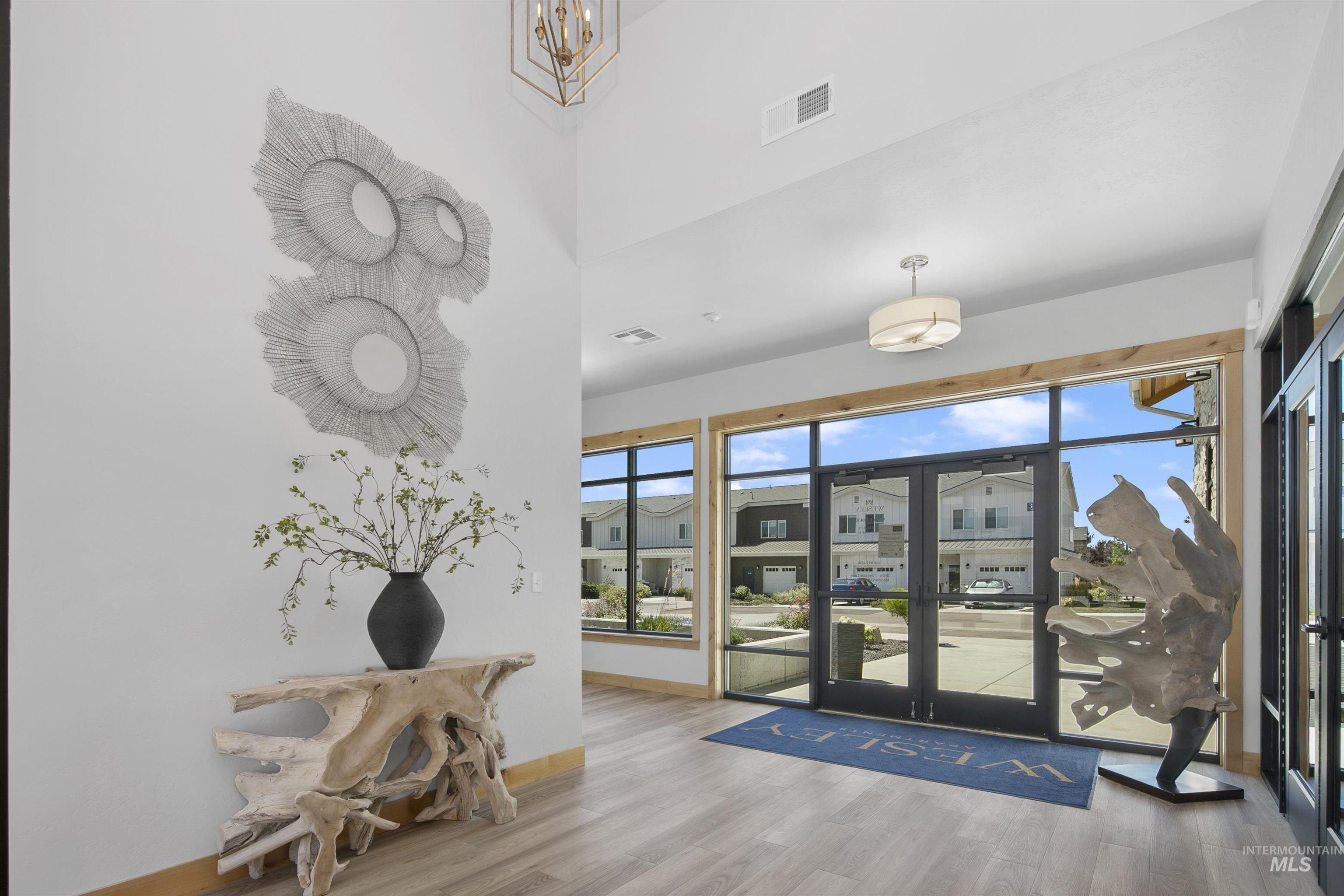 755 West Wrangler Street Meridian, ID 83646 - Photo 35 of 35 Expansive entryway featuring light wood-finish flooring, a vaulted ceiling, and large windows with black framing