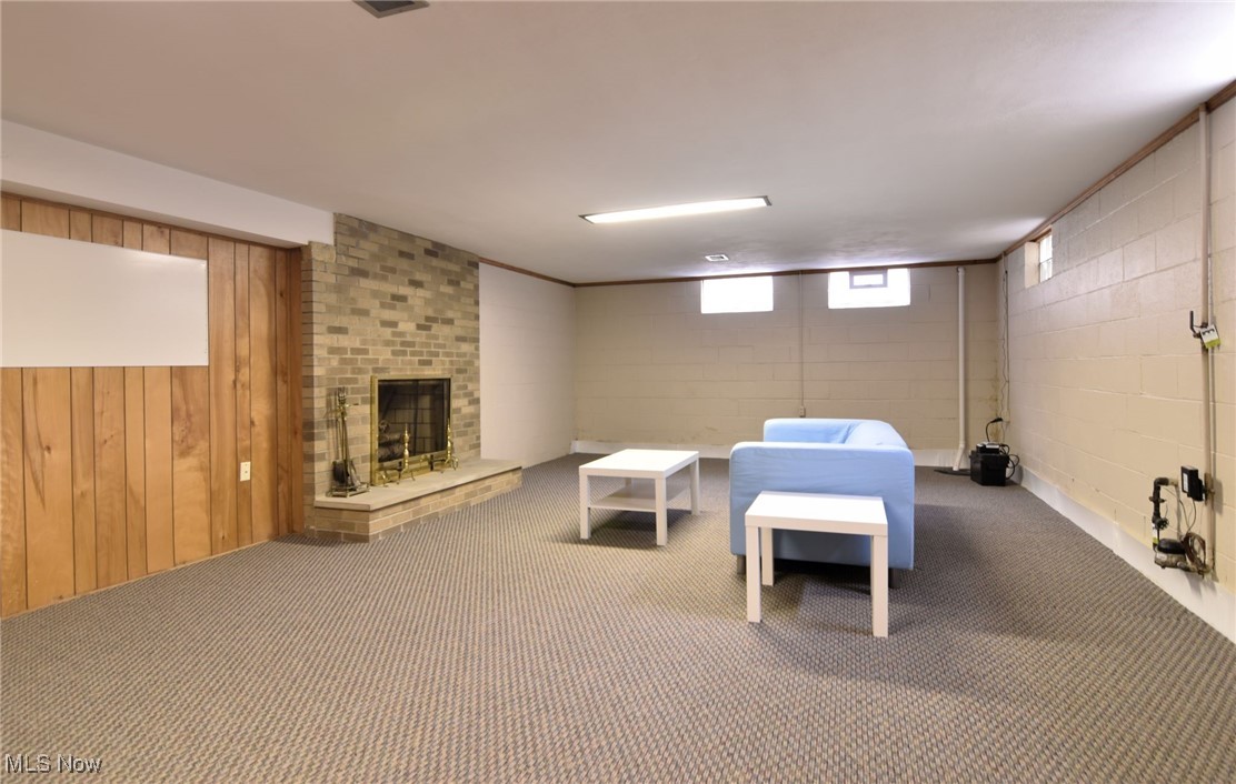 2071 Wyndham Road Akron, OH 44313 - Photo 30 of 42 Recreation room with full brick fireplace, carpet flooring, glass block windows and basement waterproofiing with transferrable warranty.