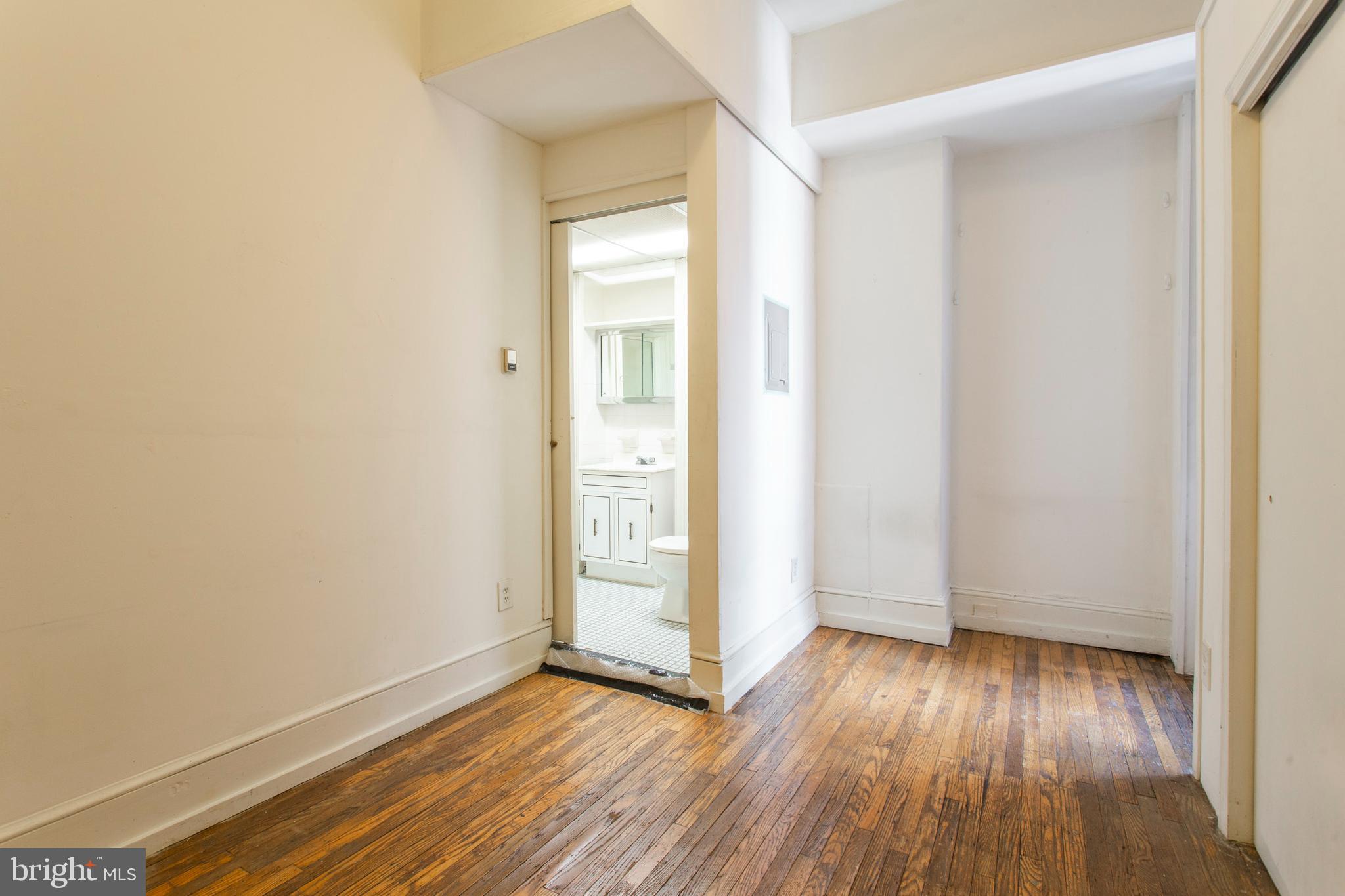 1807 Spruce Street, Unit 2F Philadelphia, PA 19103 - Photo 9 of 17 an empty room with wooden floor and windows