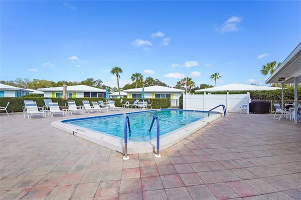 a view of a swimming pool with a lounge chair