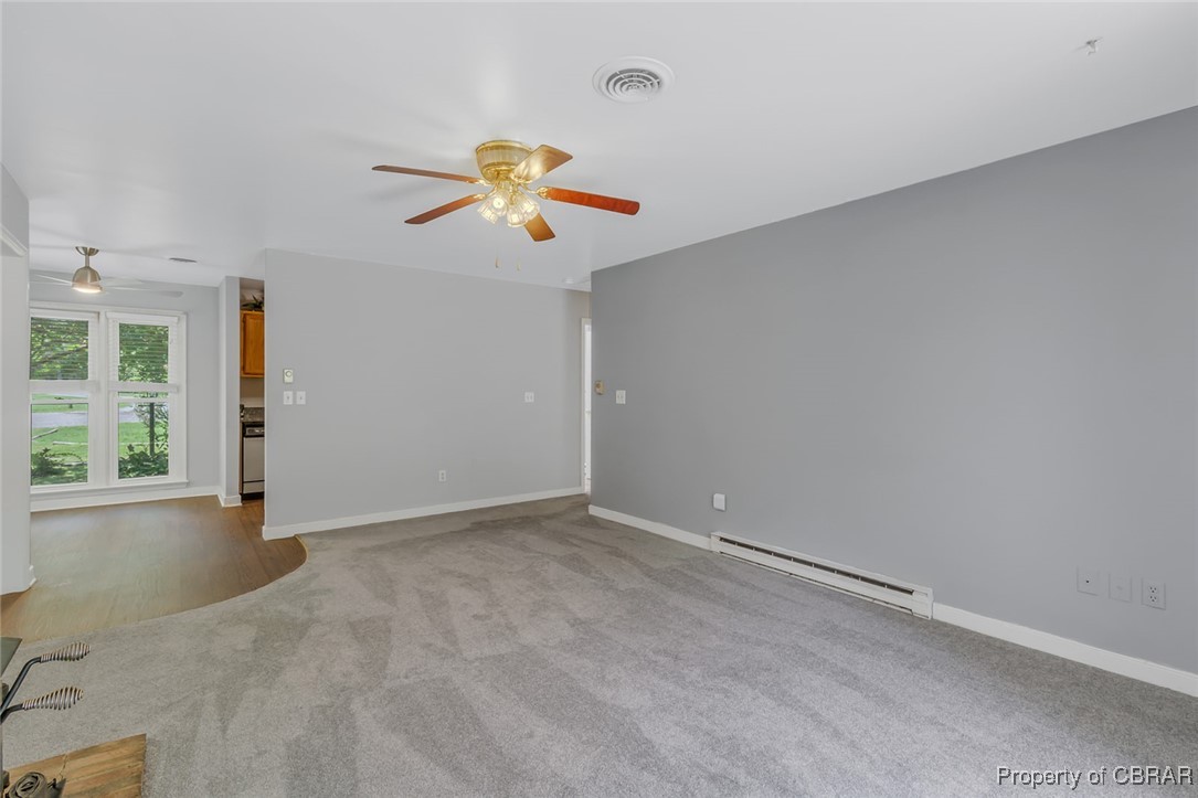 122 Old Glebe Point Road Burgess, VA 22432 - Photo 43 of 50 Spare room with a baseboard radiator, ceiling fan, and carpet floors