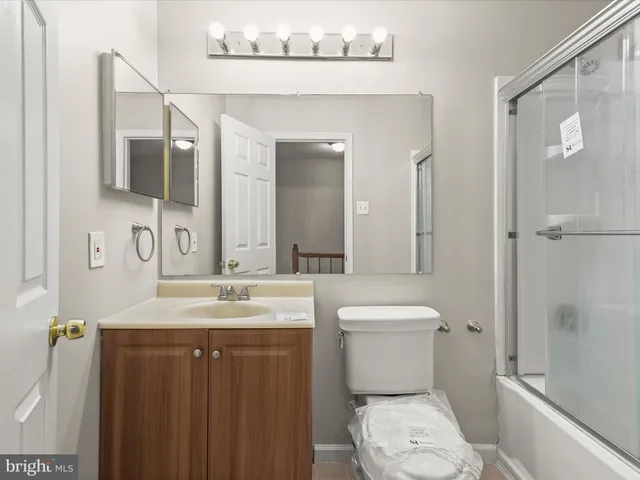 a bathroom with a toilet sink and a mirror