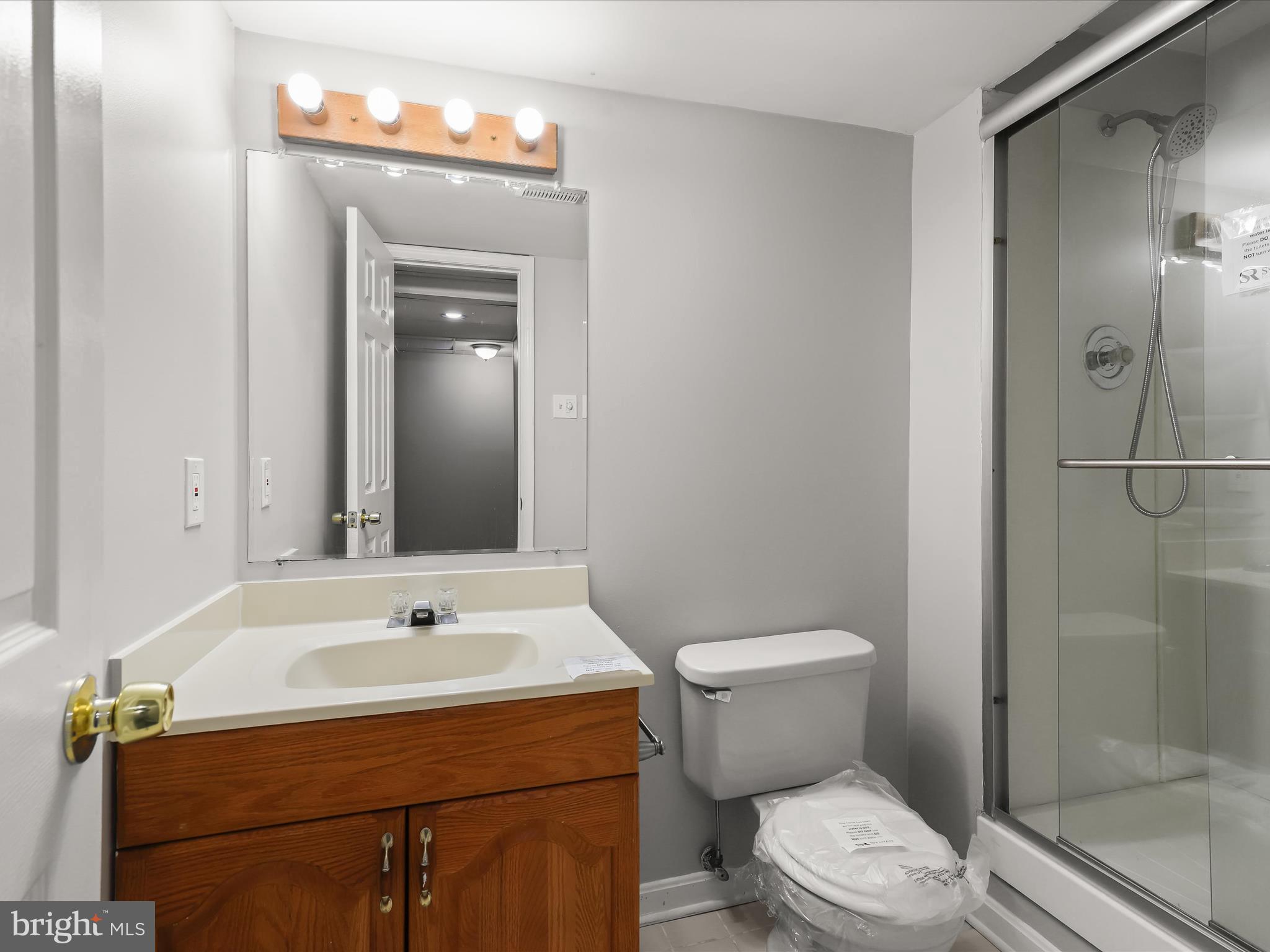 3754 Foxford Stream Road Nottingham, MD 21236 - Photo 17 of 22 a bathroom with a sink a toilet and shower