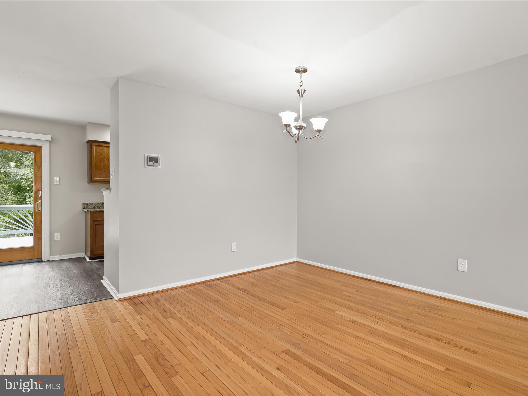 3754 Foxford Stream Road Nottingham, MD 21236 - Photo 4 of 22 wooden floor in an empty room with a window