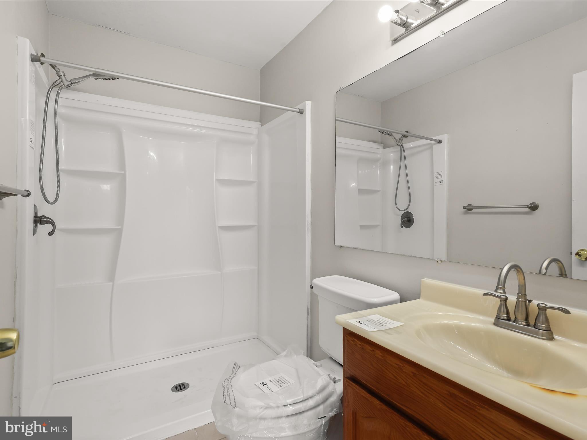 3754 Foxford Stream Road Nottingham, MD 21236 - Photo 10 of 22 a bathroom with a sink a toilet and shower