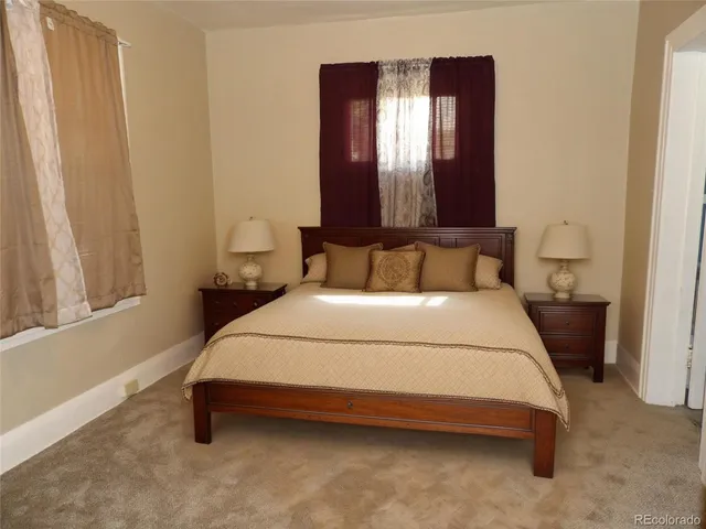 a bedroom with a bed and window