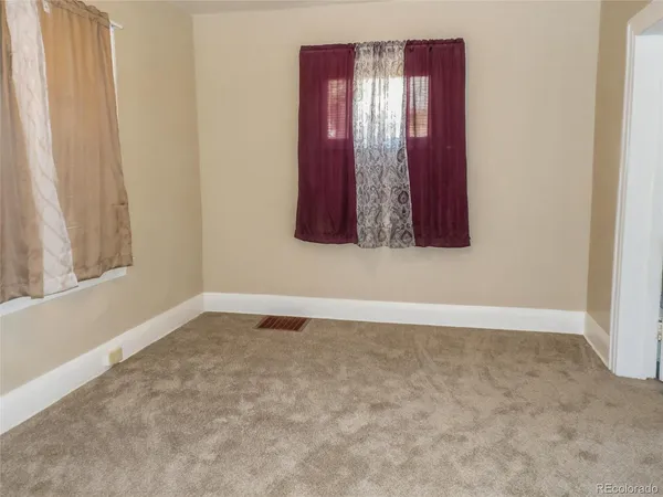 a view of wooden floor and windows in a room