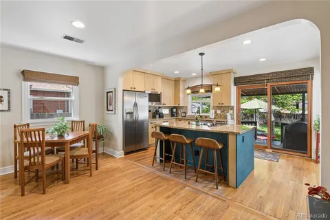 a kitchen with granite countertop kitchen island dining table and chairs