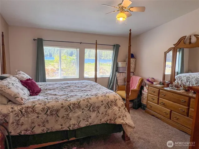 a bed sitting in a bedroom next to a window