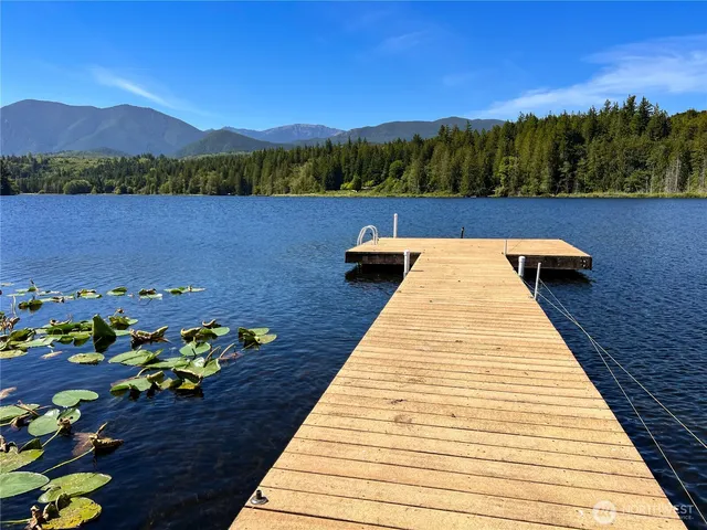 a living room with furniture kitchen view and a window