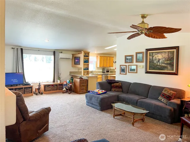 a living room with furniture a fireplace and a chandelier