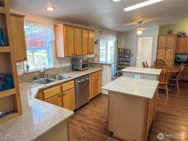 a kitchen with stainless steel appliances granite countertop a refrigerator stove and oven