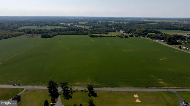 an aerial view of a houses with a lake