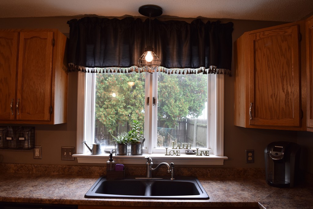 54 Luden Street Springfield, MA 01118 - Photo 4 of 24 a kitchen with large window and cabinets