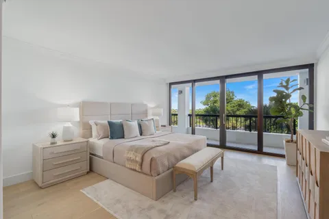 a bedroom with a large bed and a balcony view