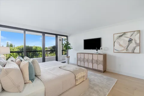 a bedroom with a large bed and a flat screen tv