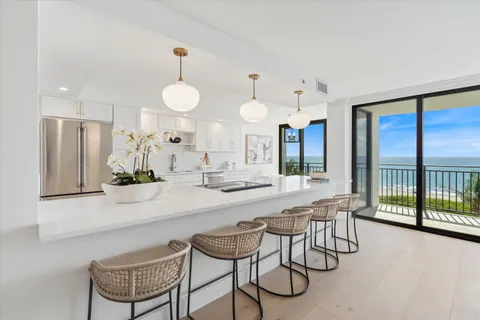 a large white kitchen with a large window