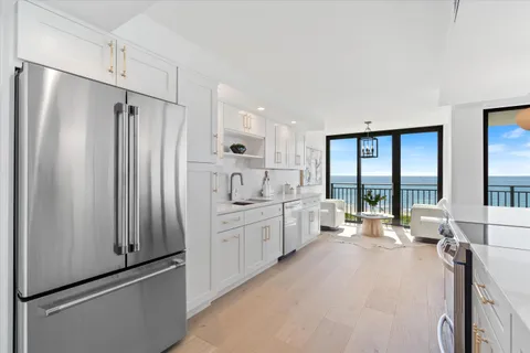 a large white room with large window and furniture