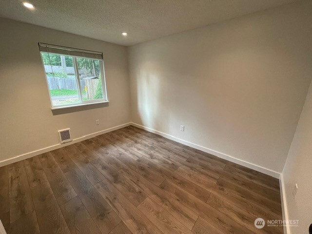 7438 Mullen Road Southeast, Unit AB Lacey, WA 98503 - Photo 22 of 37 wooden floor in an empty room with a window