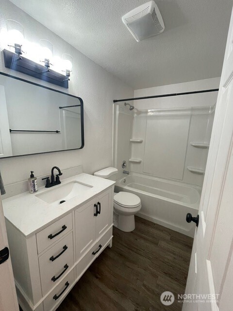 7438 Mullen Road Southeast, Unit AB Lacey, WA 98503 - Photo 26 of 37 a bathroom with a sink a toilet and mirror