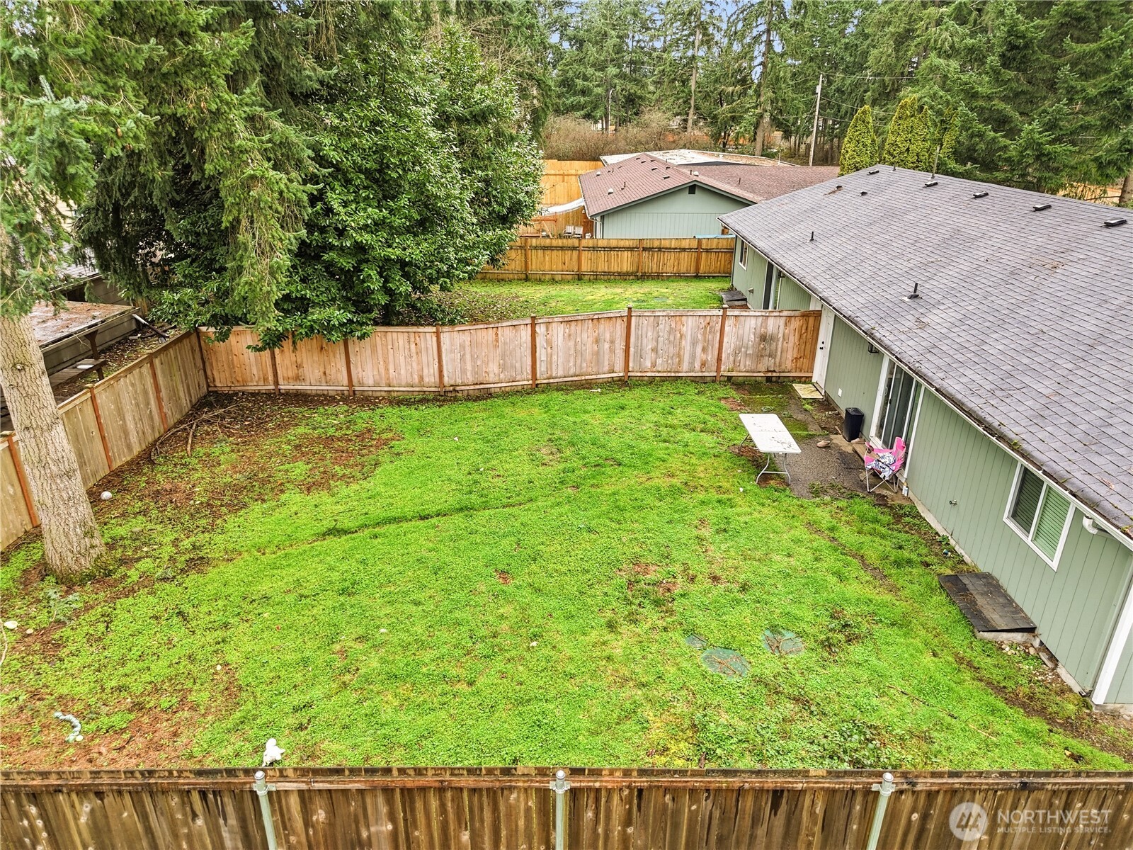 7438 Mullen Road Southeast, Unit AB Lacey, WA 98503 - Photo 4 of 37 a view of a backyard with wooden fence