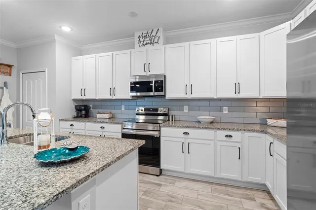 a bathroom with a granite countertop sink a toilet and shower